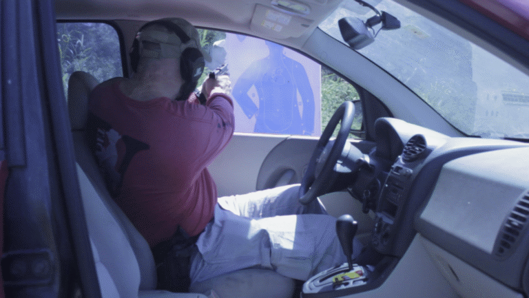 Man fires a handgun from a car toward a paper target.